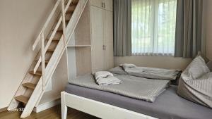 two beds in a room with a staircase at Andreas in Lenz