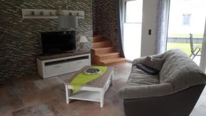 a living room with a couch and a tv at Haus Phil in Lenz