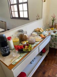 a kitchen counter with a bunch of food on it at Pousada Por do Sol in Teresópolis