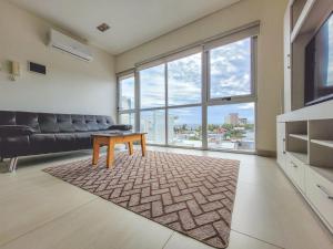 a living room with a couch and a table at Brisa Austral Comodoro in Comodoro Rivadavia