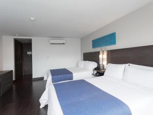 Voodi või voodid majutusasutuse Hotel bh El Poblado toas