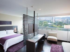 Voodi või voodid majutusasutuse Hotel bh El Poblado toas