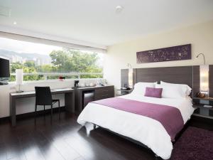 Voodi või voodid majutusasutuse Hotel bh El Poblado toas