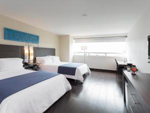 Voodi või voodid majutusasutuse Hotel bh El Poblado toas