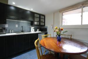a kitchen with a wooden table with a vase of flowers on it at Fiber Artist's Studio in Woodstock