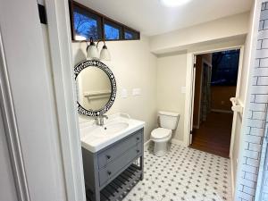 a bathroom with a sink and a mirror and a toilet at Fiber Artist's Studio in Woodstock