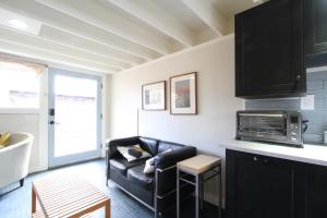 a living room with a couch and a microwave at Fiber Artist's Studio in Woodstock +7 photos