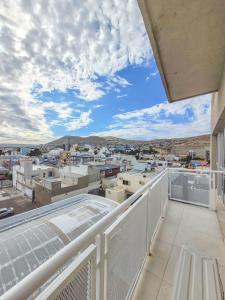 a balcony with a view of a city at Brisa Austral Comodoro in Comodoro Rivadavia