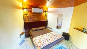 a small bedroom with a bed in a room at Mr Pakal Tulum in Tulum +27 photos
