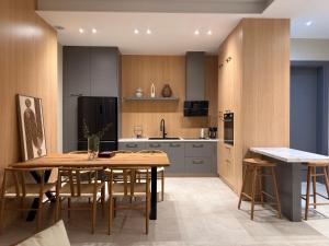 a kitchen with a table and chairs in a kitchen at Vog Villa in Tirana