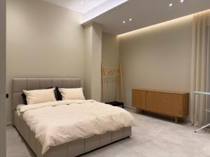 a bedroom with a large bed and a wooden cabinet at Vog Villa in Tirana +38 photos