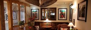 a dining room with a table and some pictures on the wall at The Bell at Hampton Poyle in Kidlington