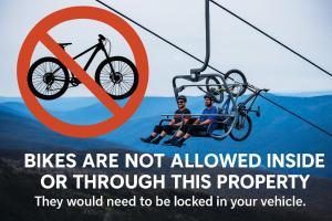 two people riding a ski lift with a bike on it at Big Nanook Squatters 32 in Thredbo