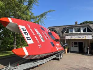 a plane on a trailer in front of a building at Hotel Belvedere in Seevetal
