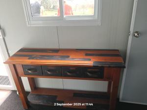 a wooden desk in a room with a window at Karamu Homestead in Karamu