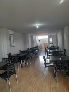 a dining room with tables and chairs in a room at Hotel Algaroba Anexo in Bom Jesus da Lapa