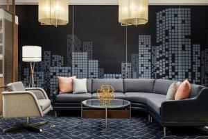 a living room with a couch and a table at Courtyard by Marriott New York Manhattan Upper East Side in New York +29 photos
