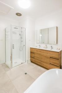 a bathroom with a shower and a sink at Merindah • Pet-Friendly • Central 4BDR for 10 in Agnes Water +27 photos