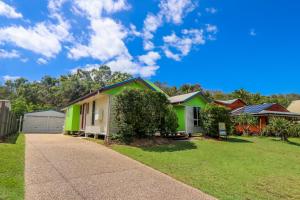 a row of houses in a yard with a sidewalk at McLeods • Pet-Friendly Central Beach House for 6 in Agnes Water