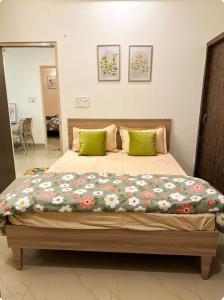 a bedroom with a large bed with flowers on it at Heartistry in Jabalpur
