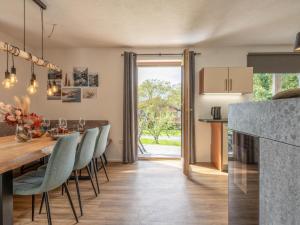 a kitchen and dining room with a table and chairs at Chalet Pölven in Schwoich