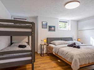 a bedroom with two beds and a bunk bed at Chalet Pölven in Schwoich
