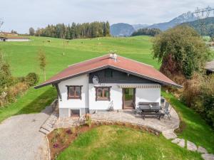 an aerial view of a small white house in a field at Chalet Pölven in Schwoich