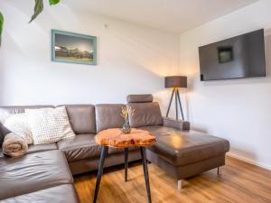 a living room with a couch and a table at Chalet Pölven in Schwoich