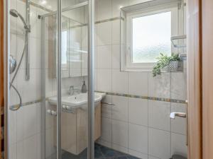 a bathroom with a sink and a shower at Chalet Pölven in Schwoich +34 photos