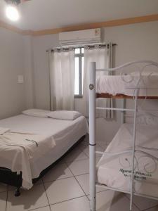 a bedroom with two bunk beds and a window at Hotel Algaroba Anexo in Bom Jesus da Lapa +20 photos