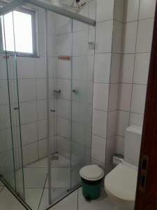 a bathroom with a toilet and a glass shower at Hotel Algaroba Anexo in Bom Jesus da Lapa