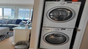 a washer and dryer in a living room at Second Floor Oceanfront Unit in Brant Beach