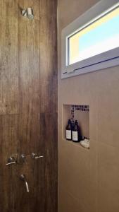 a bathroom with a shower with a window at Lirios del Cerro in Sierra de la Ventana +28 photos