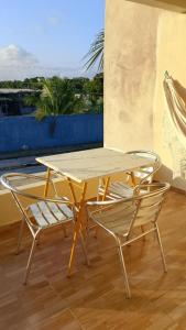 a table and chairs on a balcony with a view at Casa Sol in Cabo de Santo Agostinho