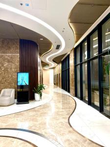 a lobby with a television in a building at Hanaco Homestay in Hai Phong