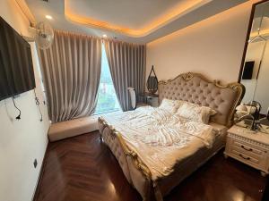 a bedroom with a large bed with a large window at Hanaco Homestay in Hai Phong +17 photos
