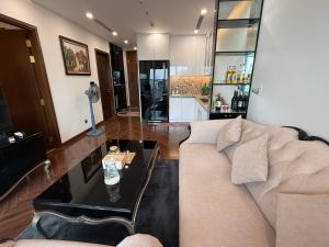 a living room with a couch and a table at Hanaco Homestay in Hai Phong