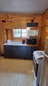 a kitchen with a sink and a stove in a room at Casa com piscina aquecida, 3 quartos e 3 camas extras in Capão da Canoa +12 photos