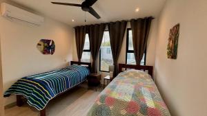 ein Schlafzimmer mit zwei Betten und einem Deckenventilator in der Unterkunft Casa de Lemon in Coco + 52 Fotos