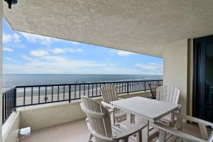 a balcony with a table and chairs and the ocean at Perdido Quay 501 by Youngs Suncoast in Orange Beach