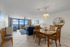 a dining room and living room with a table and chairs at Perdido Quay 501 by Youngs Suncoast in Orange Beach