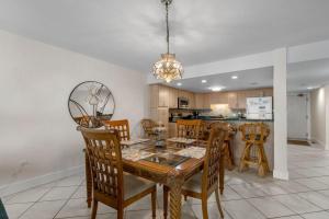 a dining room and kitchen with a table and chairs at Perdido Quay 501 by Youngs Suncoast in Orange Beach +29 photos
