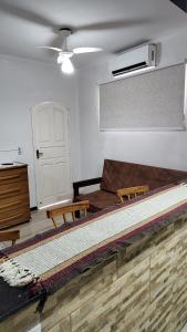 a bedroom with a large bed and a white door at Calmaria in Arraial do Cabo