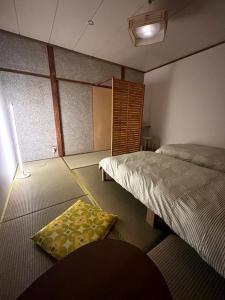 a room with two beds and a rug on the floor at MACARA Guesthouse in Nichinan +49 photos