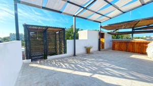 a patio with awning on top of a house at Mr Pakal Tulum in Tulum