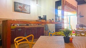 a dining room with a table and a kitchen at Mr Pakal Tulum in Tulum
