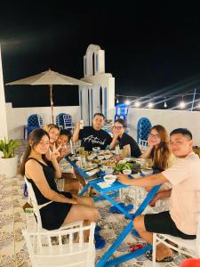 a group of people sitting around a table with food at Robinson Homestay - Cù Lao Mái Nhà in Tuy An