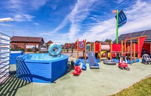 a playground with a pool and play equipment at Stunning Home In Sarbinowo in Sarbinowo +5 photos