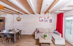 a living room with a couch and a table at Stunning Home In Sarbinowo in Sarbinowo