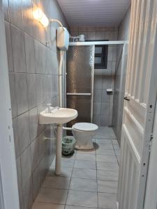 a small bathroom with a toilet and a sink at Quarto casal Nereidas bwc compartilhado in Guaratuba +28 photos